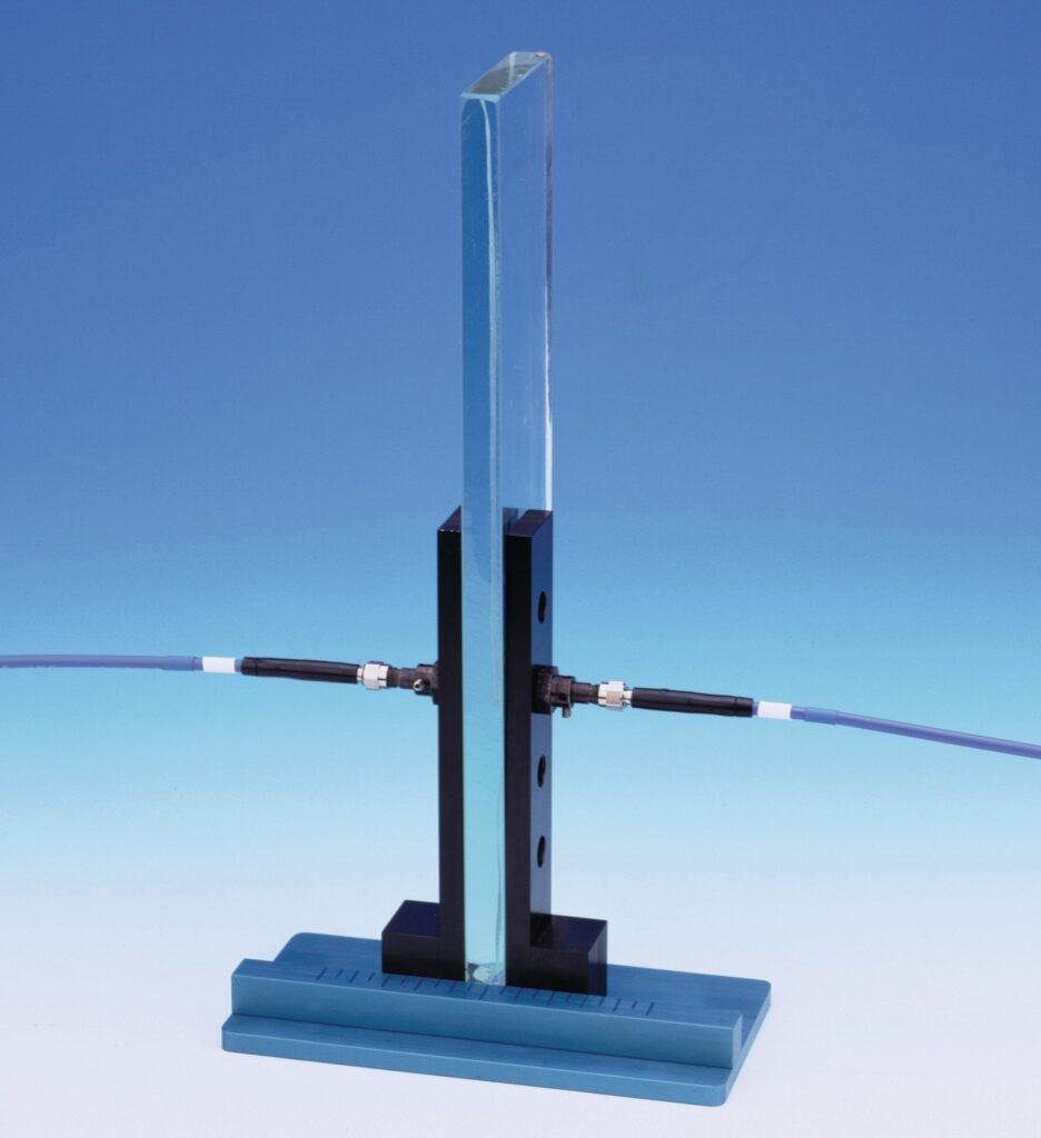 Setup where collimating lenses are attached to optical fibers flank a solid glass sample